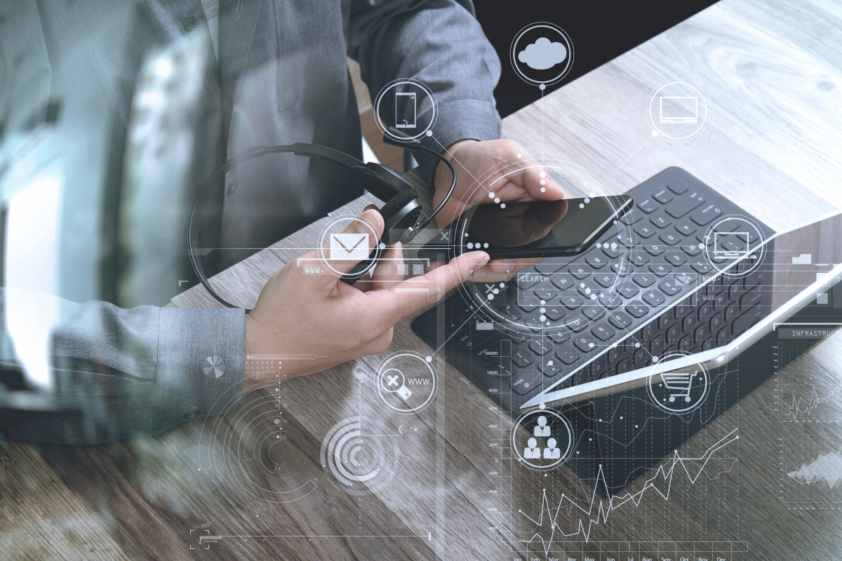 Top view of hands using VOIP headset with computer, cloud communication concept.