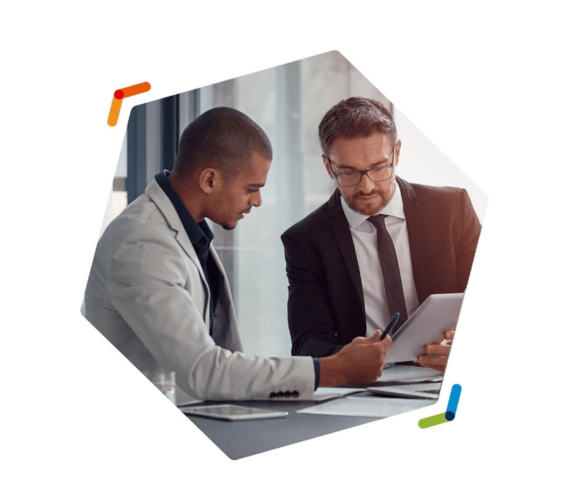 Two businessmen reviewing documents at a table