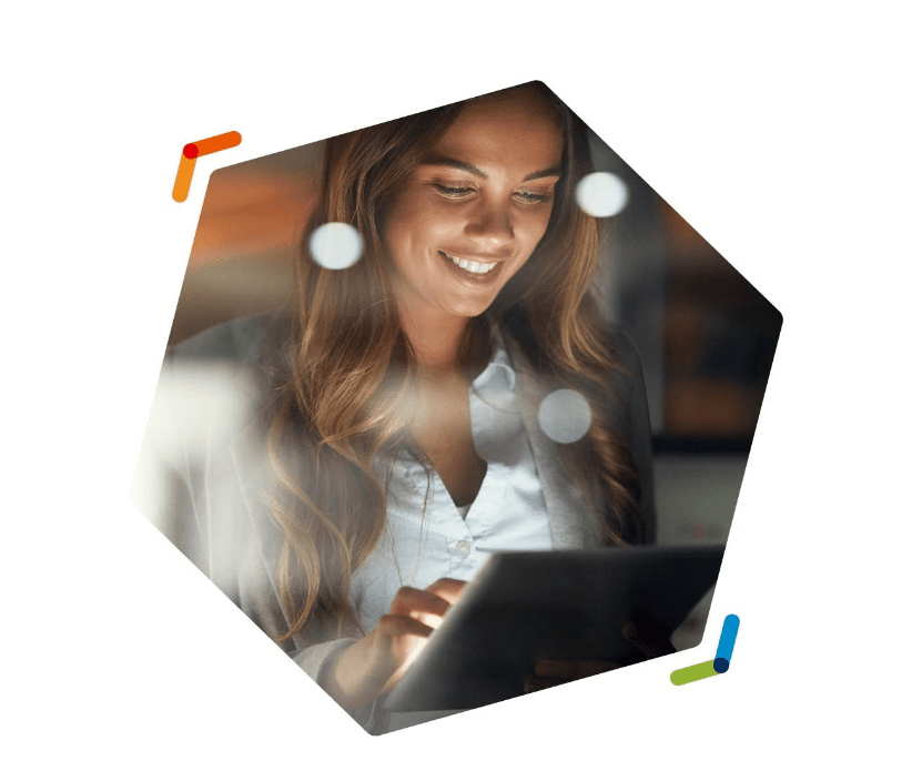 A woman smiling at a tablet